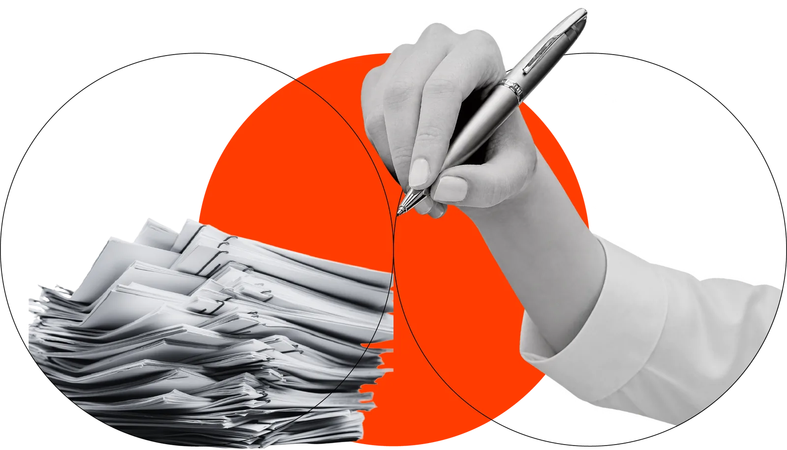 Hand writing with a pen beside a stack of papers.